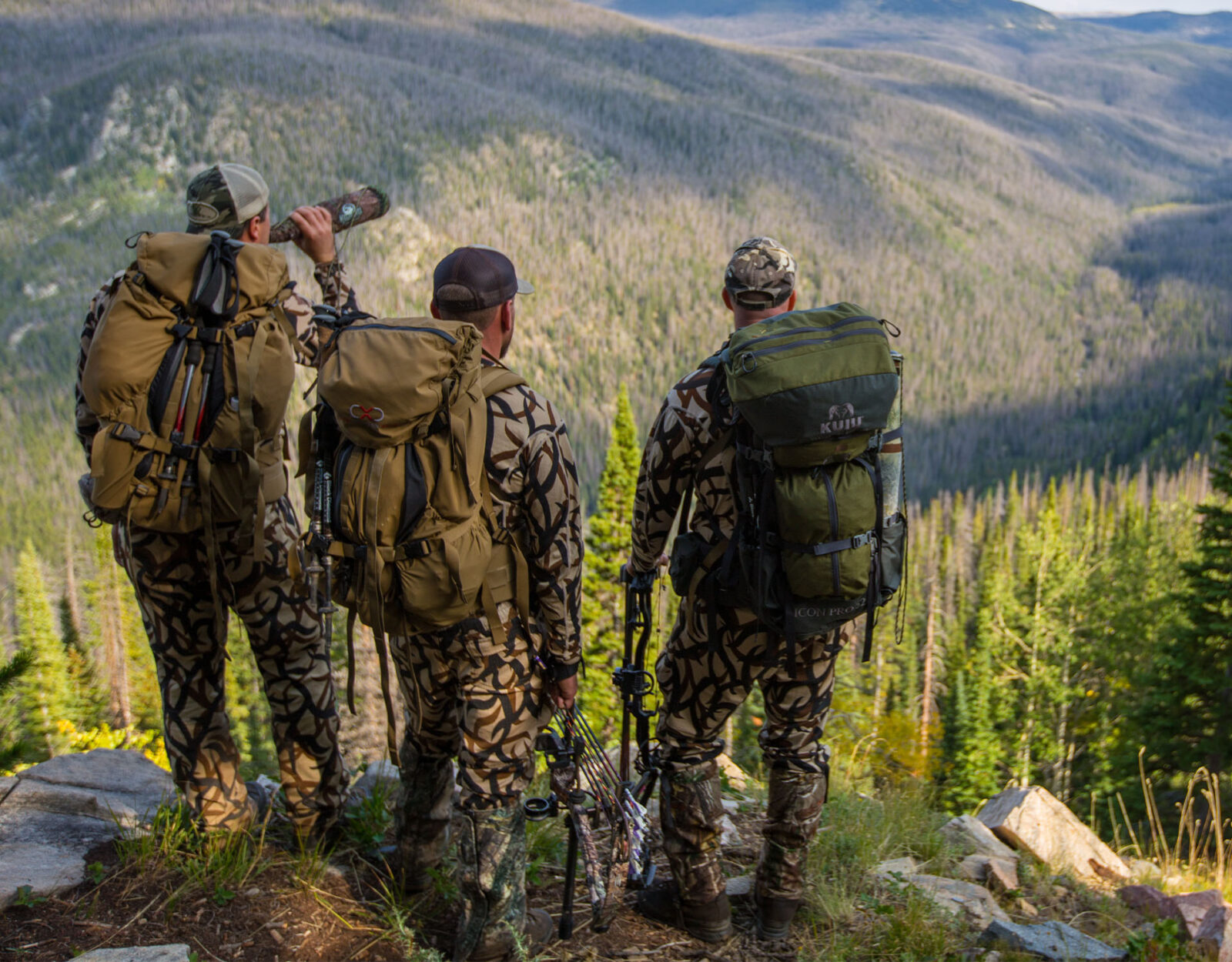 3 hunters in camo with hunting backpacks 