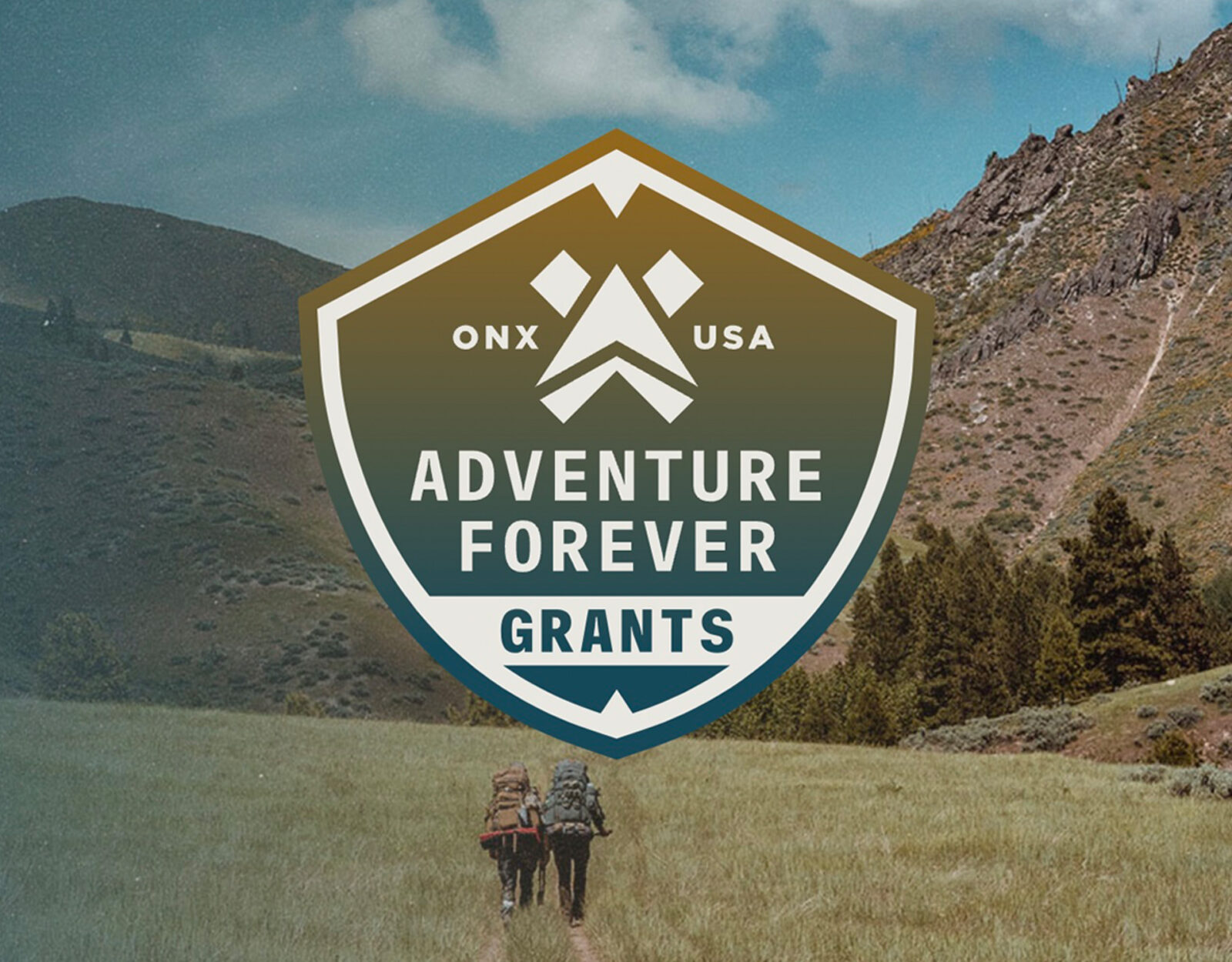 onX Maps Adventure Forever Grants logo on an image of two backpackers hiking up a mountain 