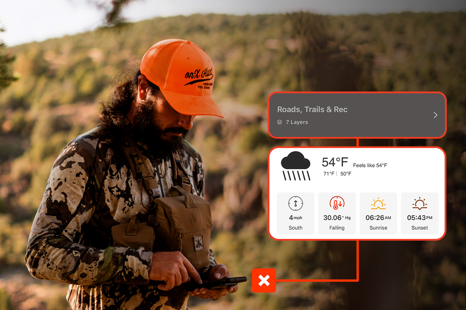 A hunter in full camo using the onX Hunt app. The app is showing the different layers, like weather. 