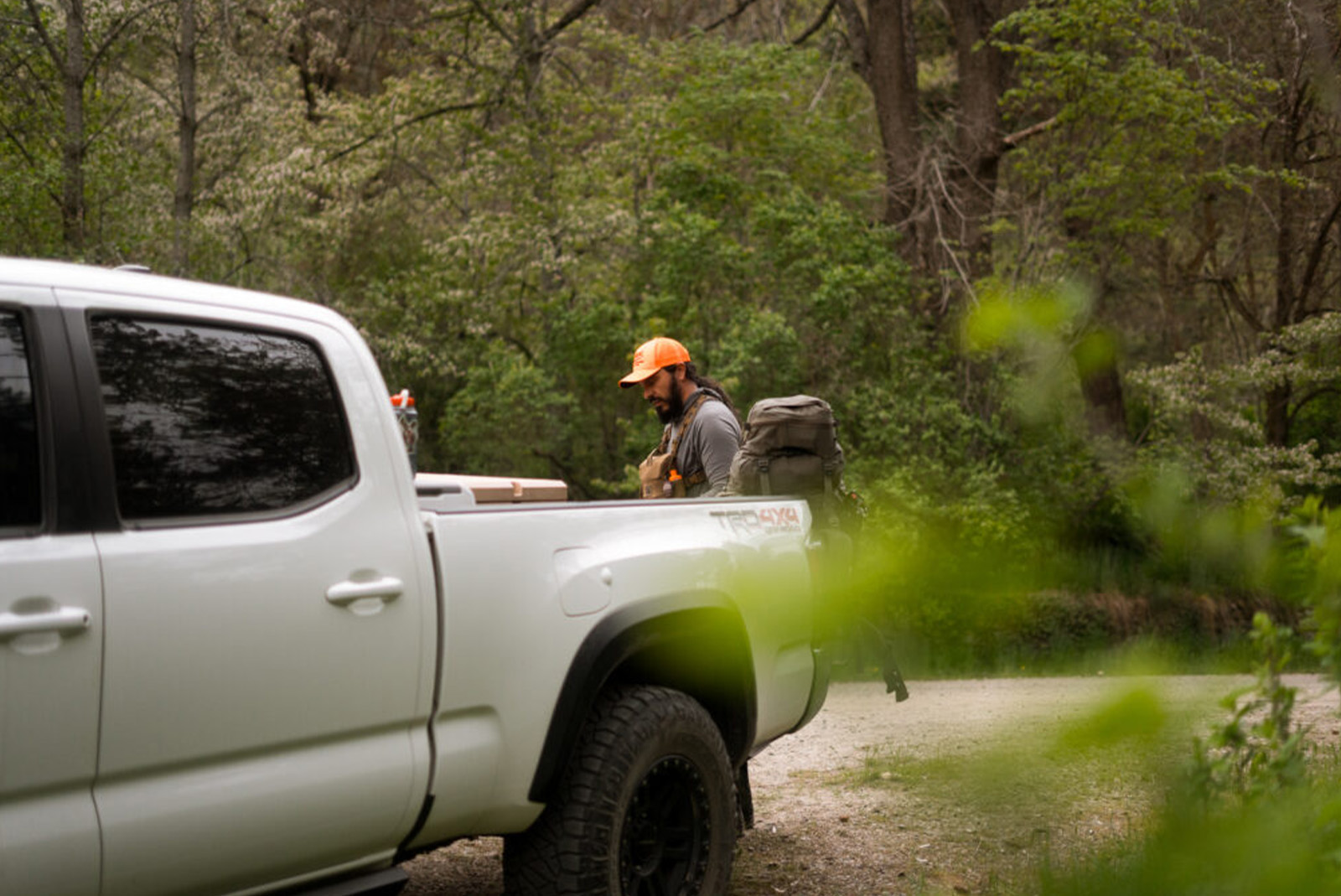 Man with truck at trailhead while hunting.