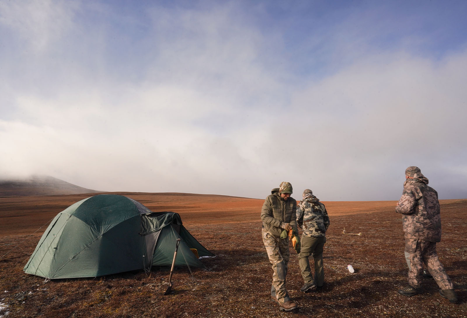 Three hunters at their Arctic basecamp.